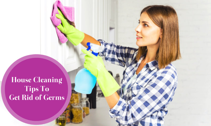 young beautiful woman wiping kitchen cabinet
