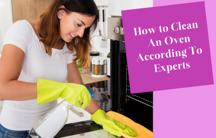 happy young woman wiping the oven