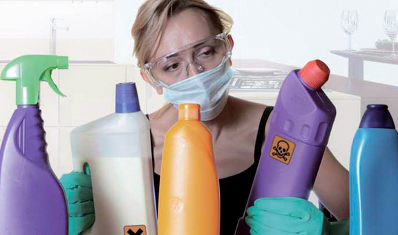 a woman with a mask holding some chemicals in hands