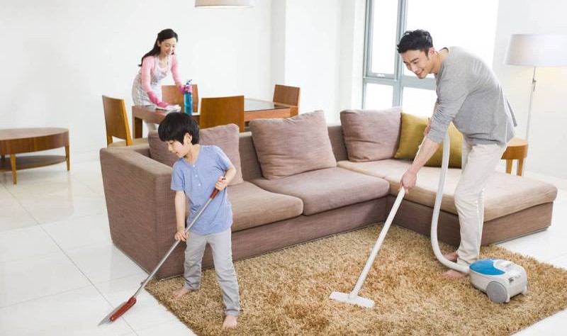 Entire family making efforts to make their house tidy