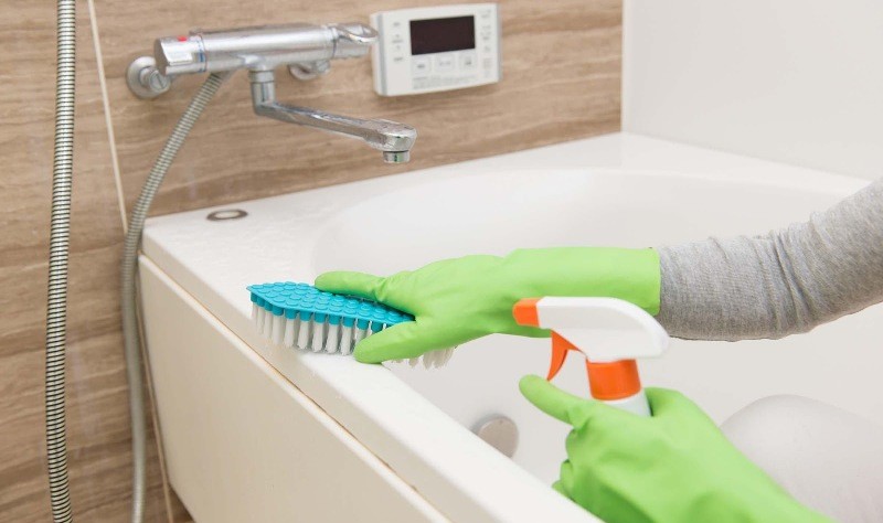 cropped picture of a person sprucing a bathtub