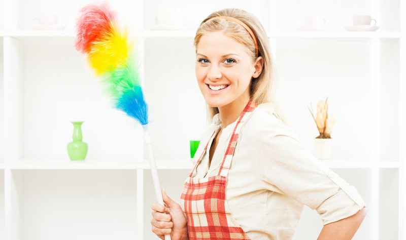young woman with a cleaning duster ready to spruce a house