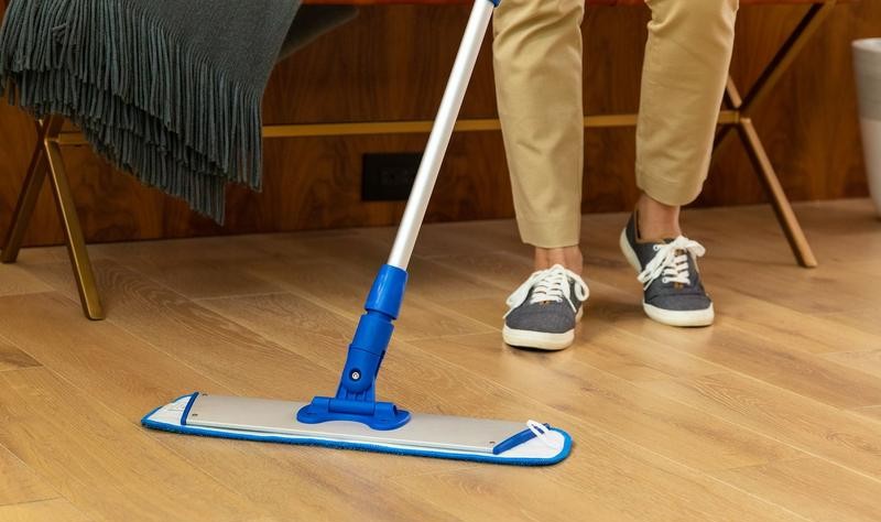 cropped picture of a man wiping hardwood floor