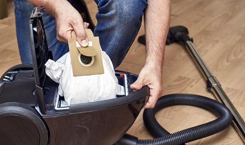 Cropped image of a man repairing a vacuum cleaner