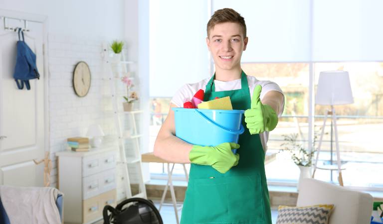 Man holding a blue basket pointing his thumb finger