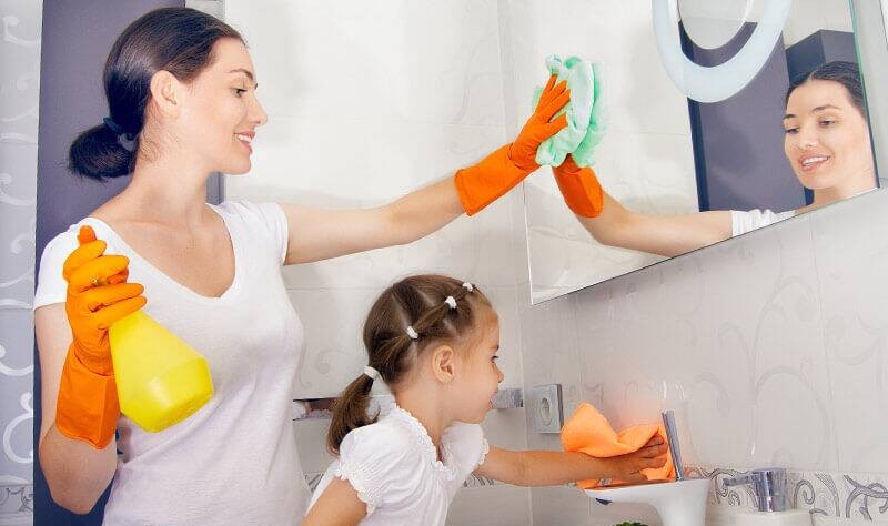 young mother and daughter sprucing up their bathroom