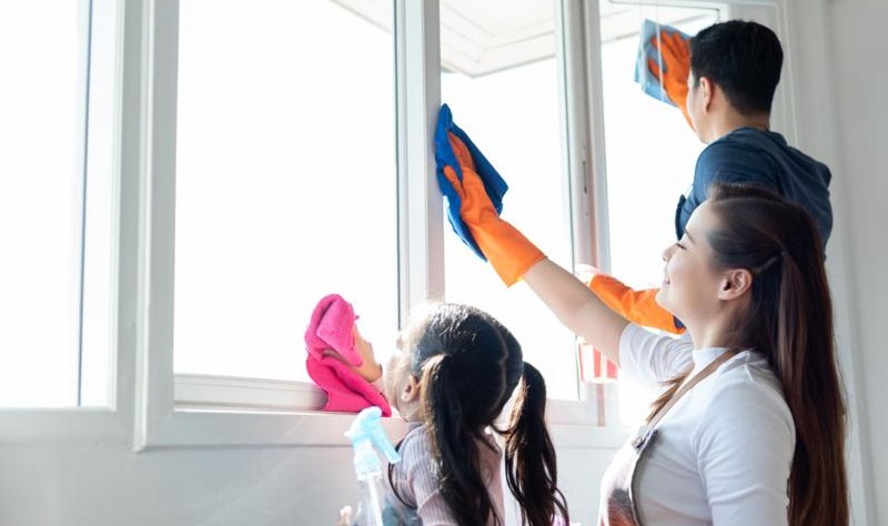 entire family sprucing up a window