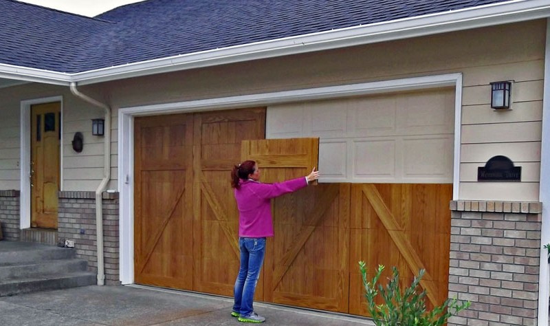 A women is fixing something on the wall