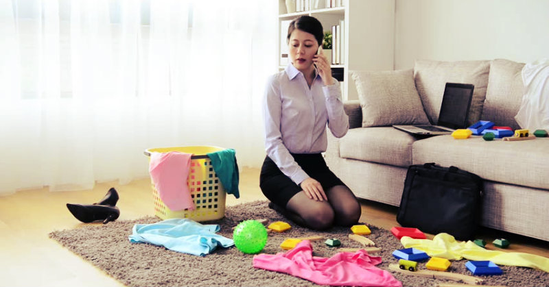 lady talking on phone and looking at the messy room