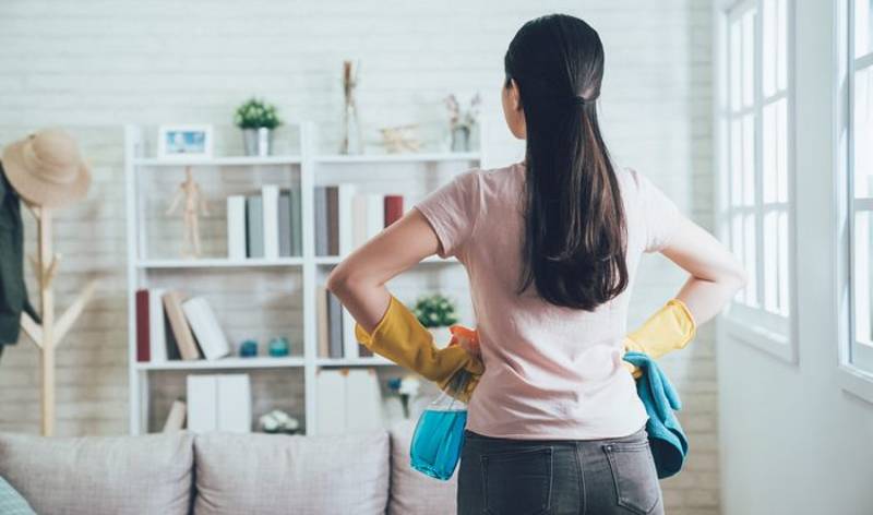 Girl thinking to clean a living room