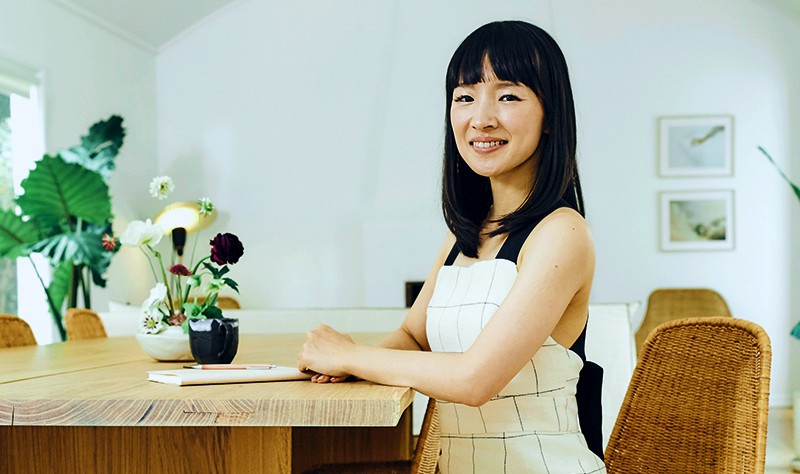 a woman sitting in a chair and posing for a picture