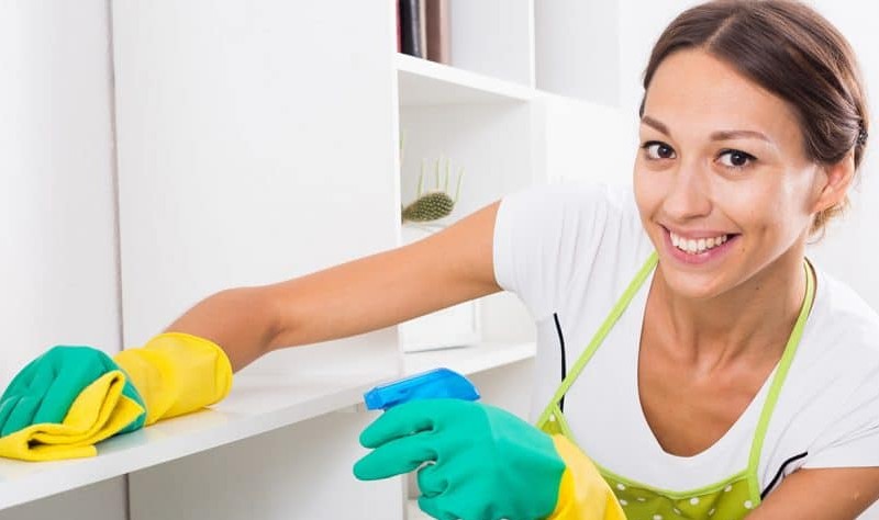 young woman wiping a surface with a cloth mop