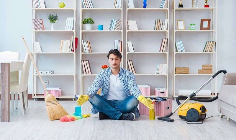 young man sitting on the floor and preparing to spruce up his house