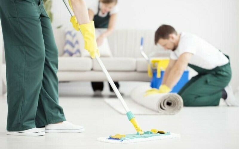 group of professionals making a room tidy