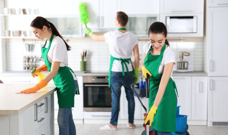 group of professionals sprucing up a kitchen