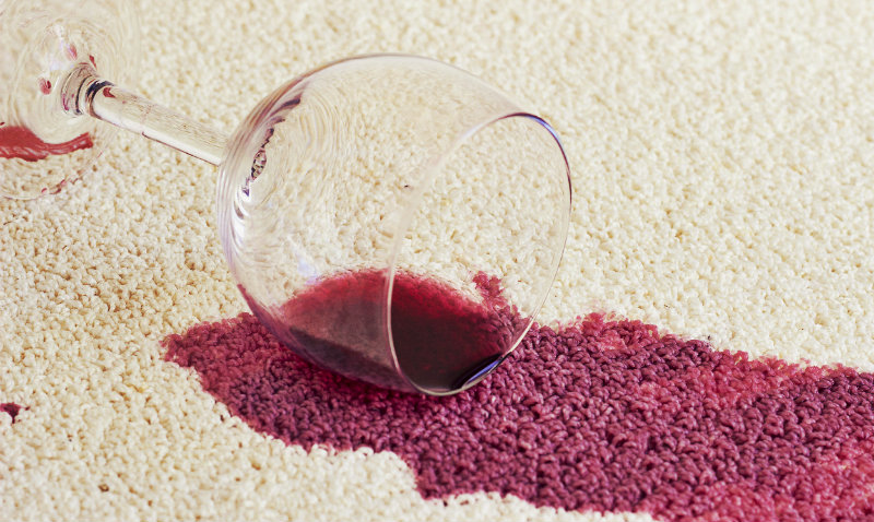 A glass of red wine spill on the carpet