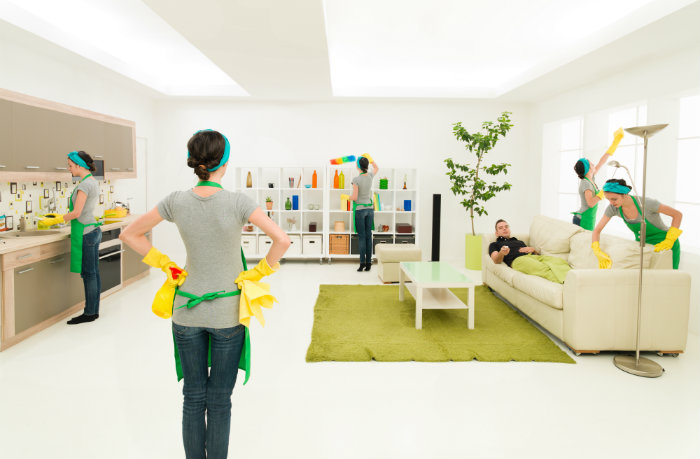 lady standing and assuming herself dusting the house