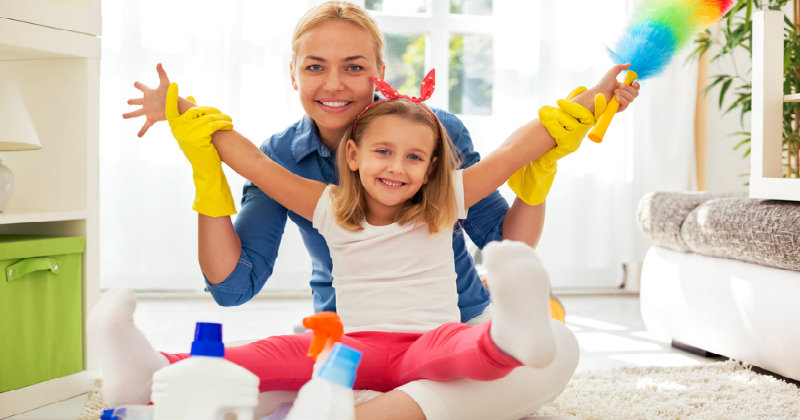 smiling mother and daughter sitting on the floor