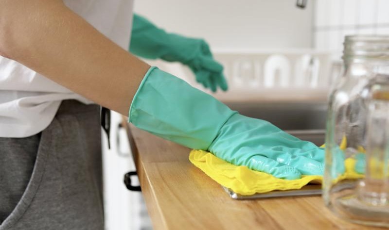 cropped picture of a woman wiping a surface with a cloth