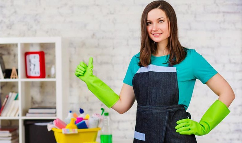 young woman inside of a house preparing to spruce up a house