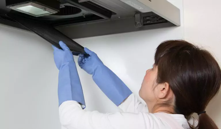 young woman cleaning an air duct