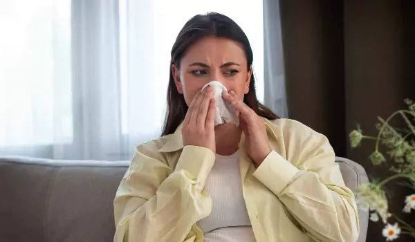 woman suffering from allergies at home