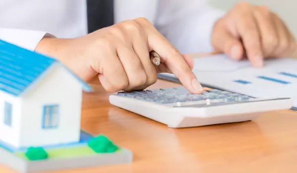 cropped picture of a person calculating something on a calculator