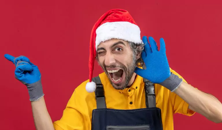 young man wearing christmas cap wearing cleaning gloves