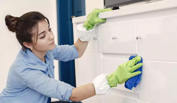 woman cleaning a cabinet