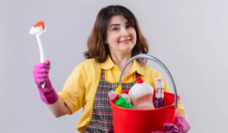 young woman with cleaning supplies