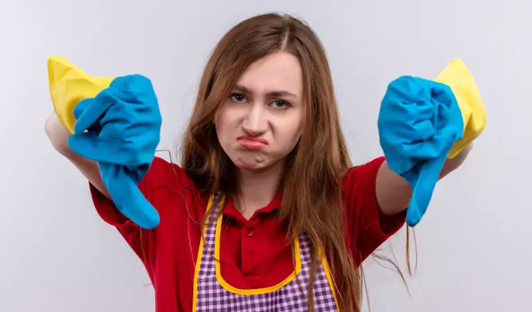young woman is looking worried and wearing blue gloves