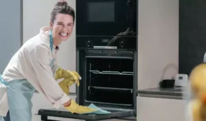 woman cleaning kitchen appliance