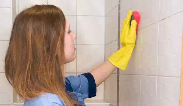 woman cleaning dirty tiles