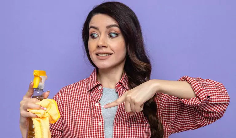 woman posing with a cleaning spray
