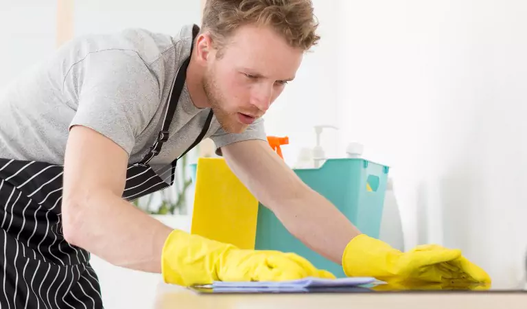 young man cleaning a surface