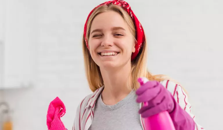 young woman with a cleaning spray ready to clean