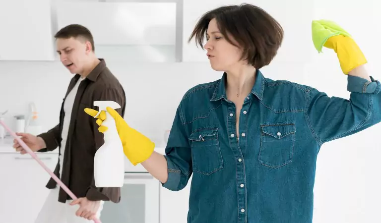 couple ready with their cleaning tools and equipment