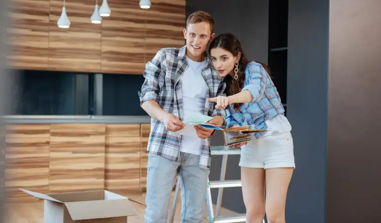 Woman in white shorts and check shirt pointing somewhere and a man in check shirt looking at the point.