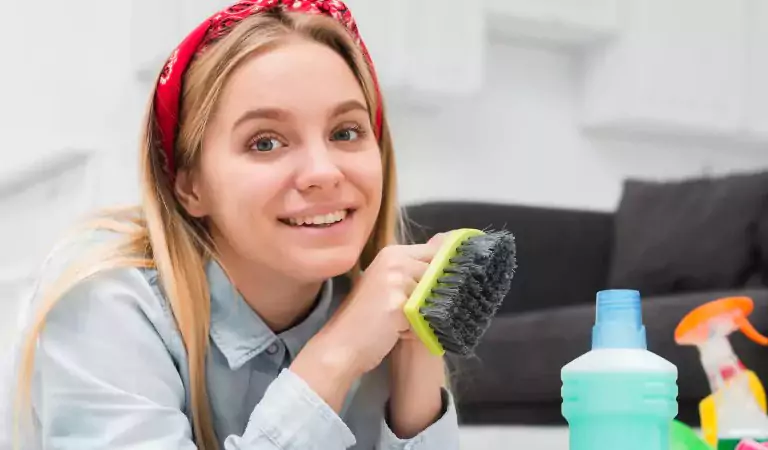 woman with some cleaning supplies ready to clean
