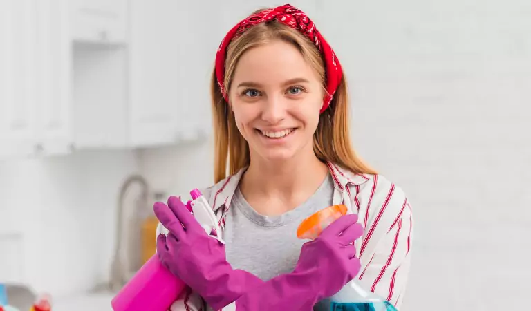 woman with some cleaning supplies ready to clean