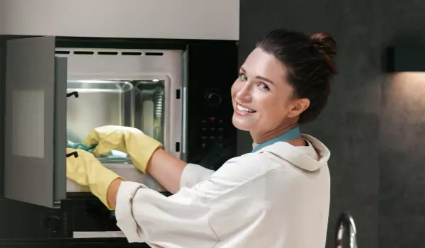 woman cleaning an oven