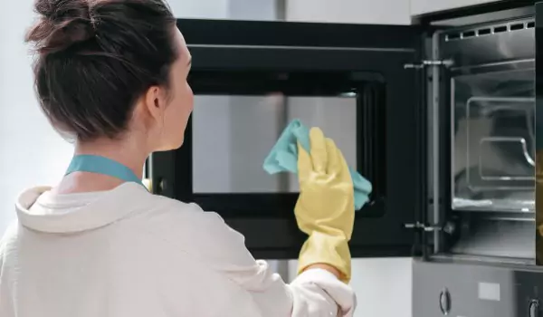 woman cleaning an oven