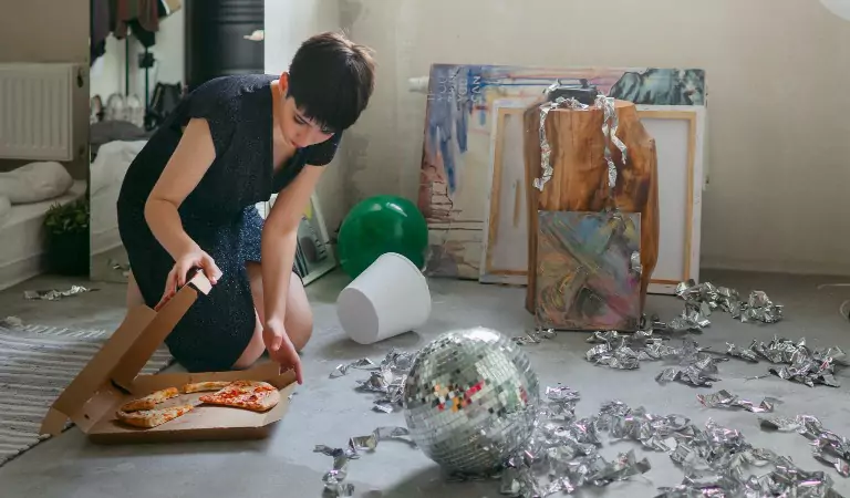 woman cleaning the mess after the party