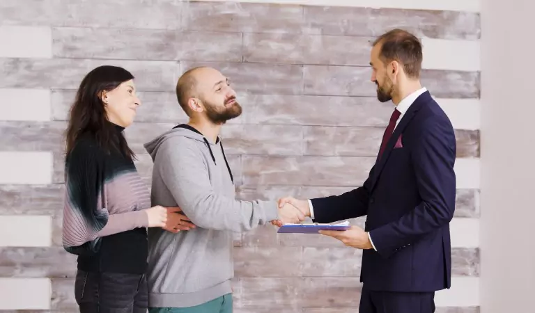 couple with their property manager inside of a house