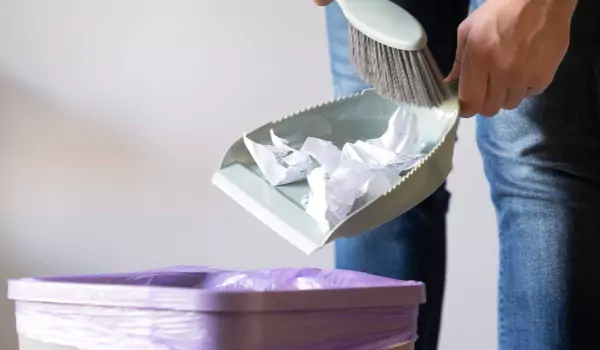 cropped picture of a person using a trash can
