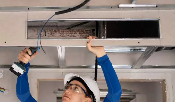 professional cleaning air vent inside of a house