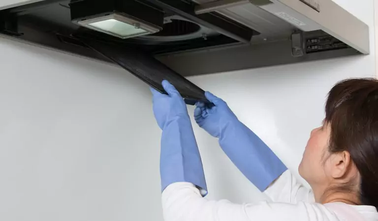 woman cleaning an air vent