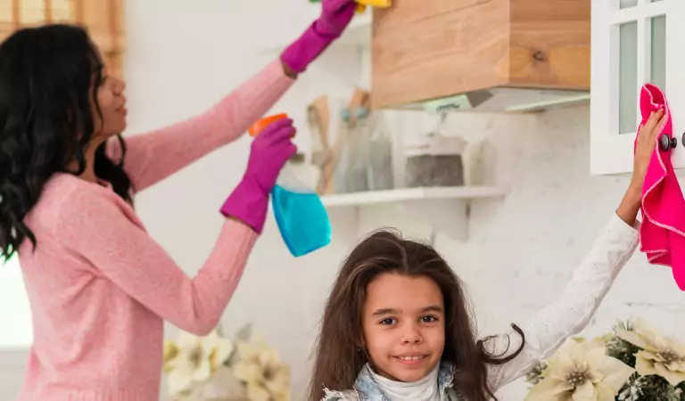 young woman wiping a surface with a cloth mop with her daughter