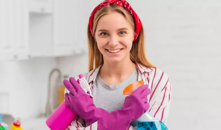 Young woman with some cleaning supplies ready to clean